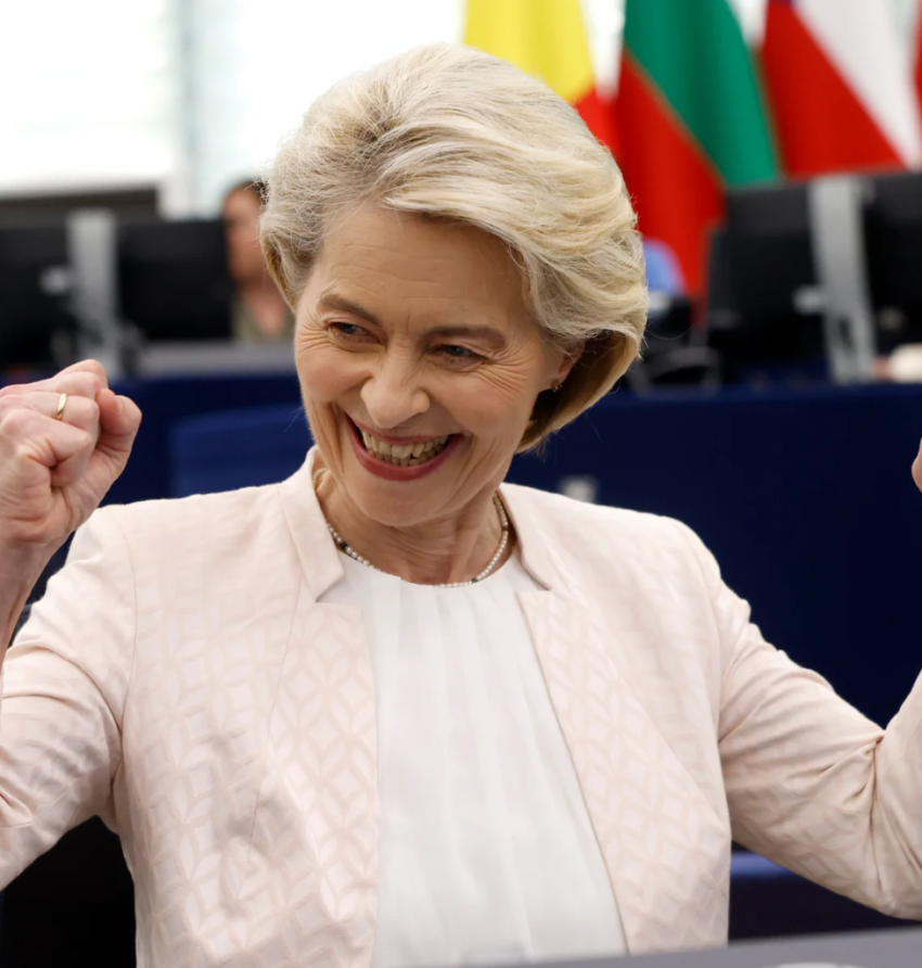 A woman celebrating with a joyful expression and clenched fists.